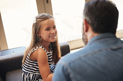 Buy stock photo Shot of an adorable little girl spending quality time with her father at home