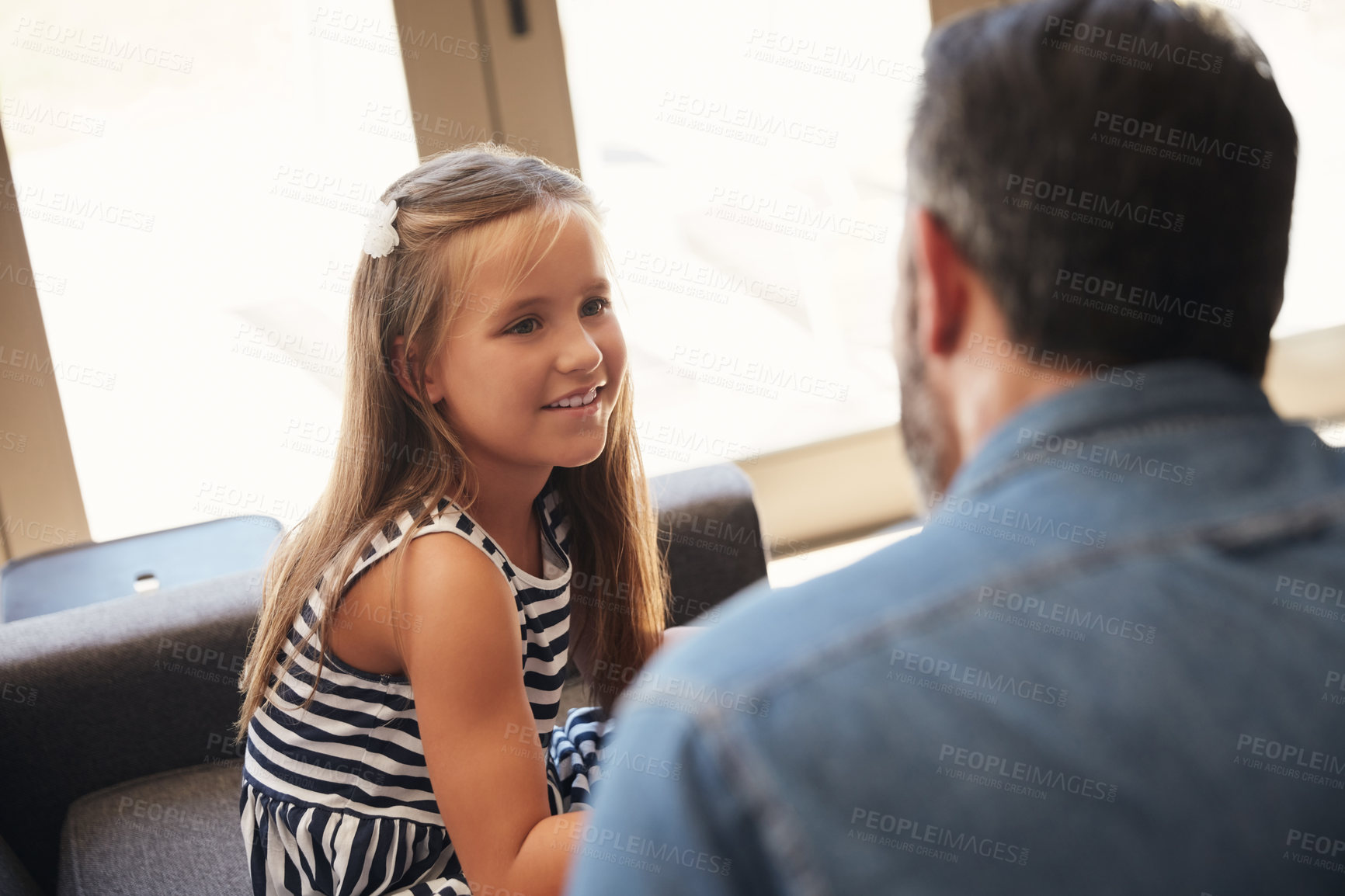 Buy stock photo Shot of an adorable little girl spending quality time with her father at home