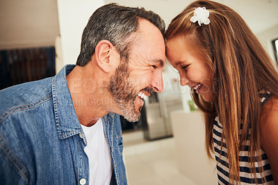 Buy stock photo Shot of an adorable little girl spending quality time with her father at home