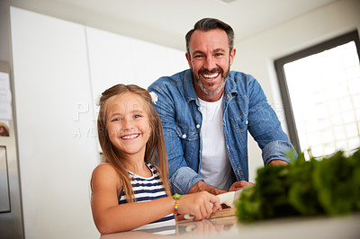 Buy stock photo Shot of an adorable little girl cooking with her father at home