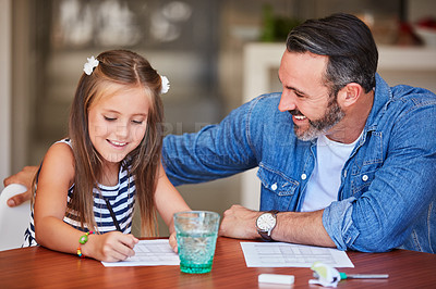 Buy stock photo Shot of a mature man helping his daughter with her homework at home