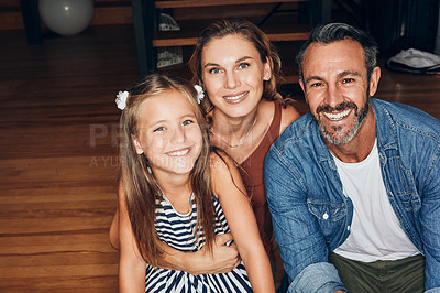 Buy stock photo Portrait of an adorable little girl spending quality time with her mother and father at home