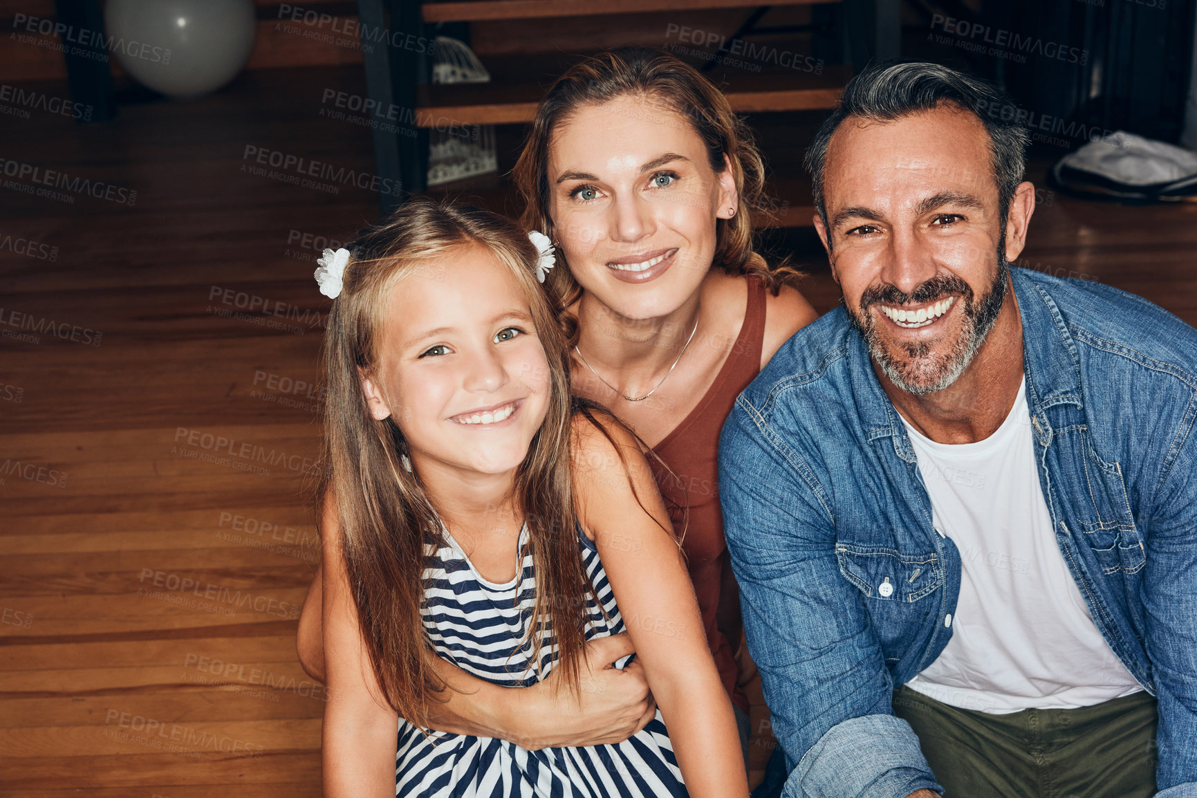 Buy stock photo Portrait of an adorable little girl spending quality time with her mother and father at home