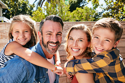 Buy stock photo Portrait of a happy young family spending quality time in their backyard at home