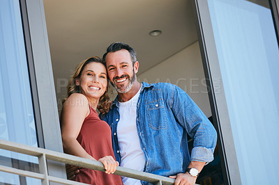 Buy stock photo Portrait of a happy couple standing on the balcony of their home