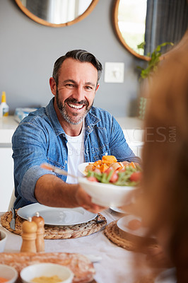 Buy stock photo Shot of a happy mature man having a meal with his wife at home