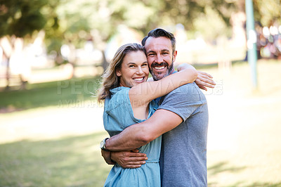 Buy stock photo Shot of a happy couple embracing in the park