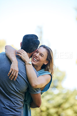 Buy stock photo Shot of a happy couple embracing in the park