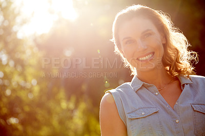 Buy stock photo Portrait of a beautiful young woman enjoying a day in the park