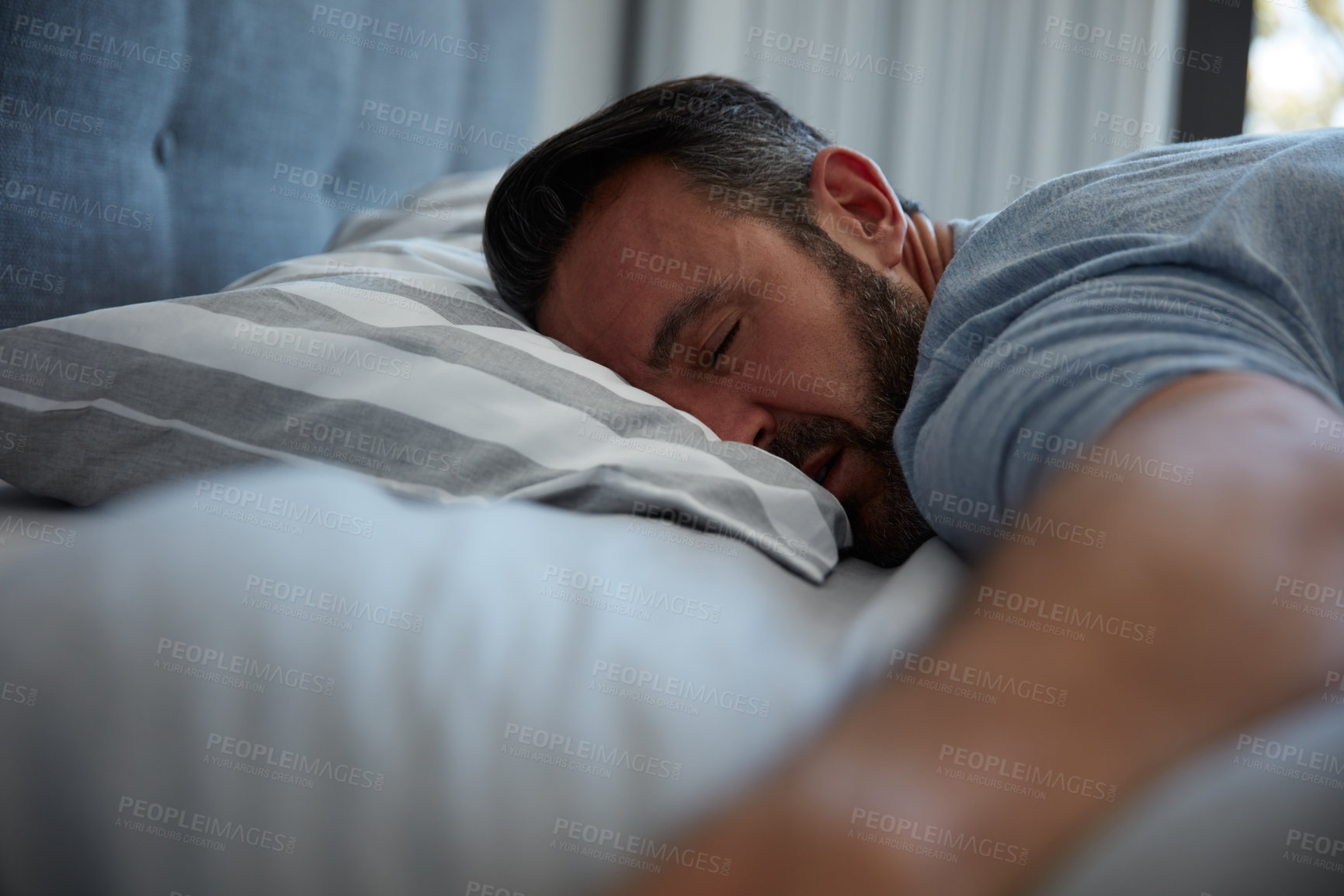 Buy stock photo Cropped shot of an attractive mature man fast asleep on his bed at home