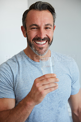 Buy stock photo Cropped portrait of a mature man holding a glass of water at home in the morning