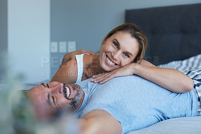 Buy stock photo Cropped shot of an attractive young woman lying on her husband's chest in their bedroom