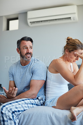 Buy stock photo Cropped shot of a mature man talking to his upset wife in the midst of a disagreement in the bedroom