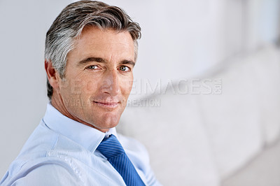 Buy stock photo Headshot of a confident mature businessman wearing a suit and tie while sitting indoors