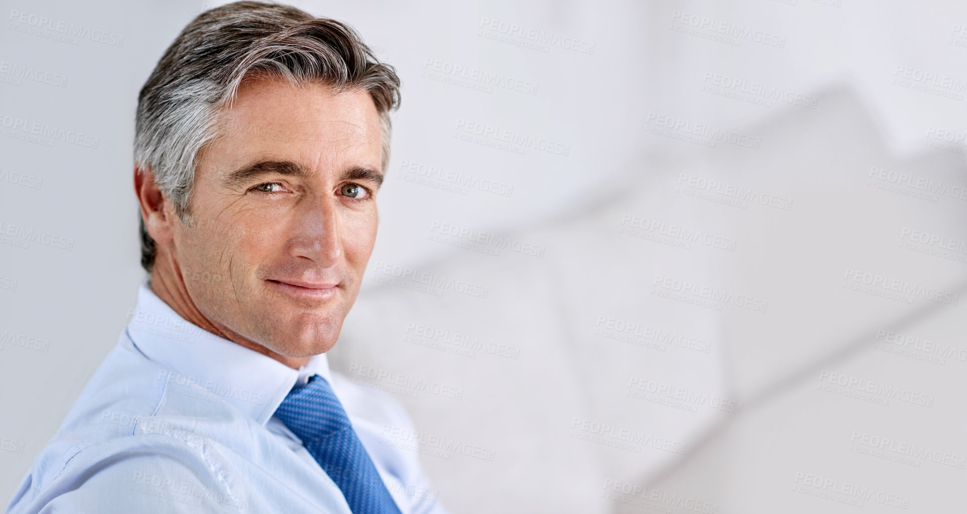 Buy stock photo Headshot of a confident mature businessman wearing a suit and tie while sitting indoors