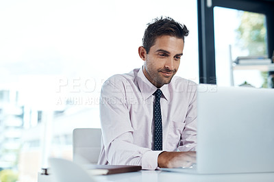 Buy stock photo Cropped shot of a businessman sitting with his laptop in his office