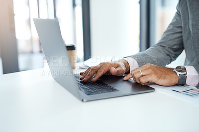 Buy stock photo Cropped shot of an unrecognizable businessman using a laptop