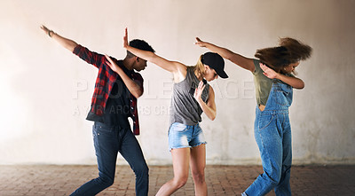 Buy stock photo Cropped shot of a young diverse group of dancers performing a routine against a walled background outdoors
