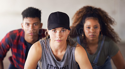 Buy stock photo Portrait of a young diverse group of dancers performing a routine against a walled background outdoors
