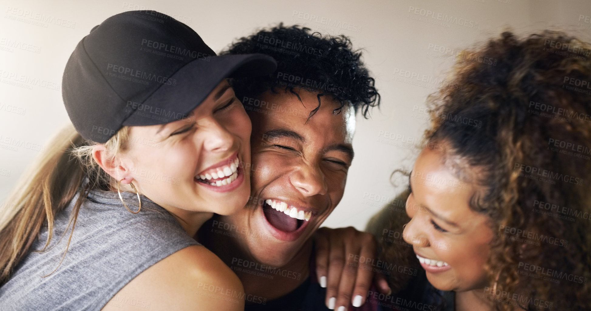 Buy stock photo Cropped shot of a young diverse group of dancers holding each other and laughing against a walled background outside