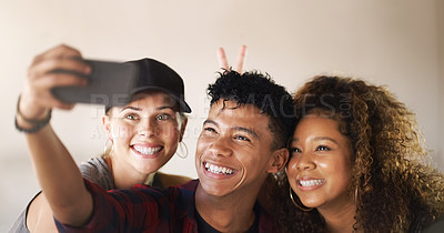 Buy stock photo Cropped shot of a young diverse group of dancers standing against a walled background and smiling for a selfie