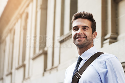 Buy stock photo Shot of a handsome young businessman on his morning commute to work