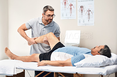 Buy stock photo Shot of a senior man going through rehabilitation with his physiotherapist