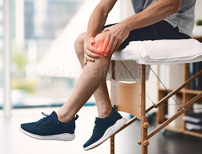 Buy stock photo Shot of an unrecognizable man holding his knee in pain