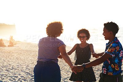 Buy stock photo Cropped shot of an attractive young trio of women enjoying a day out together on the beach during the day