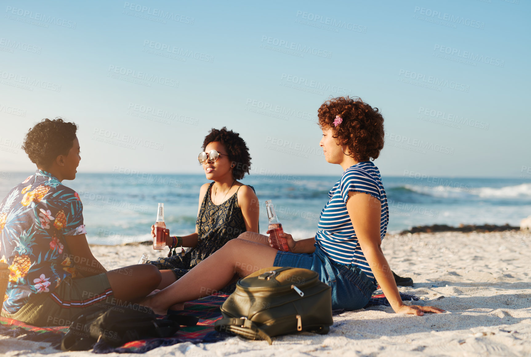 Buy stock photo Friendship, women or picnic on beach with drinks, travel or enjoy sunshine in summer. Girls, students or relax at ocean for bonding, social or unwind from exam with soda, chatting or happy in nature