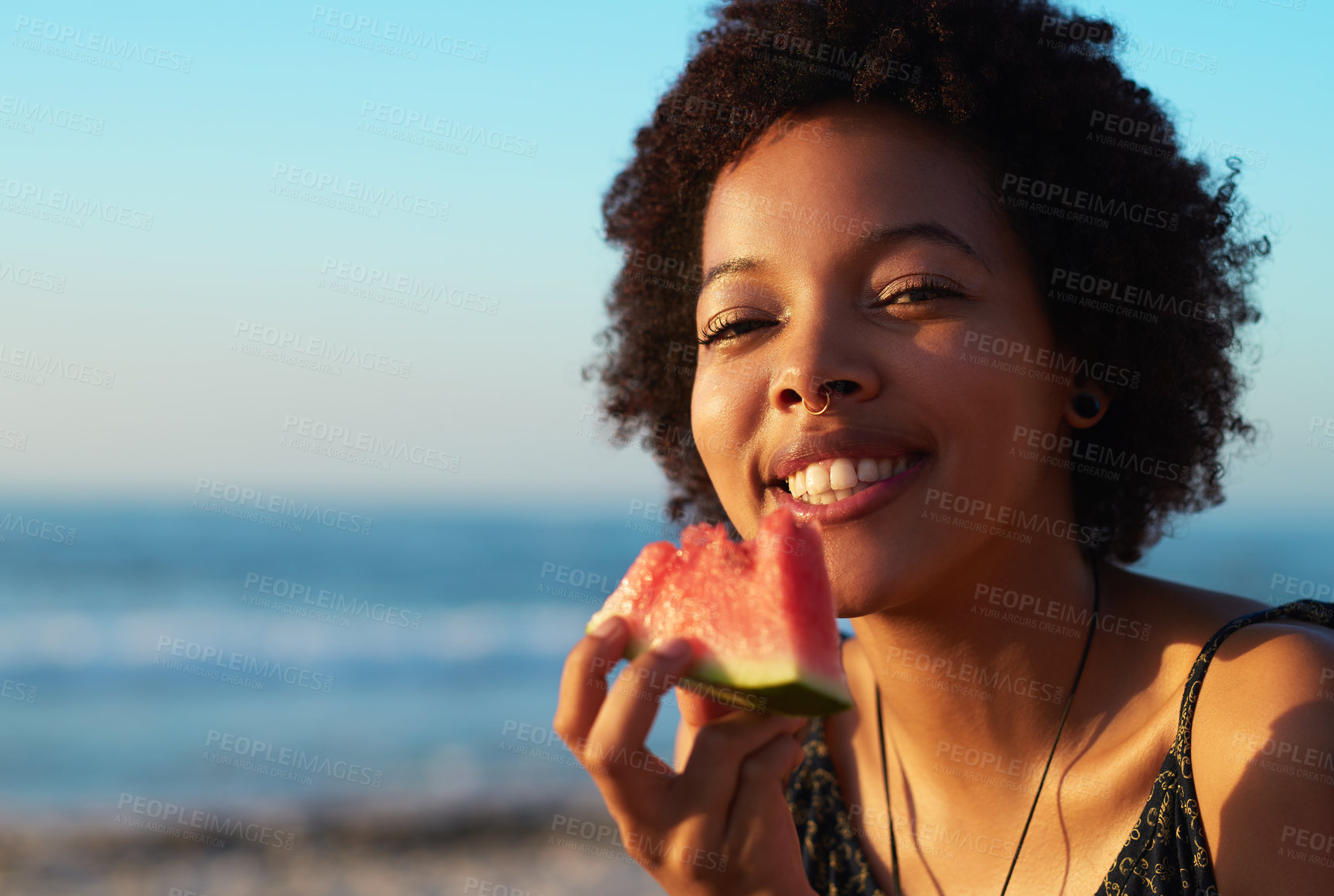 Buy stock photo Portrait, eating and black woman with watermelon, outdoor and relax in beach, smile and bite of fruit. Nature, travel and happy in holiday, ocean and food for person in vacation, enjoy in weekend