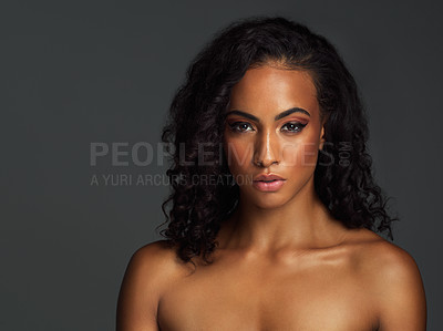 Buy stock photo Portrait of an attractive young woman posing alone shirtless and against a dark background in the studio