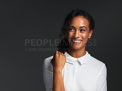 Buy stock photo Studio shot of a single attractive young woman wearing a white blouse and smiling against a dark background
