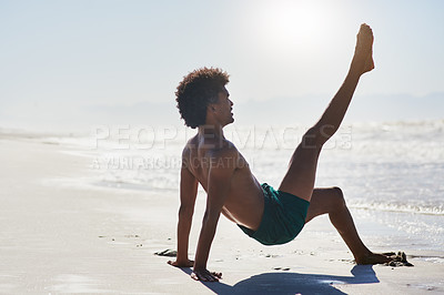 Buy stock photo Full length shot of a handsome young man performing a challenging dance sequence on the beach during the day