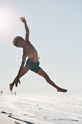 Buy stock photo Full length shot of a handsome young man mid air while dancing on the beach during the day