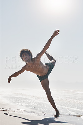 Buy stock photo Full length shot of a handsome young man performing a challenging dance sequence on the beach during the day