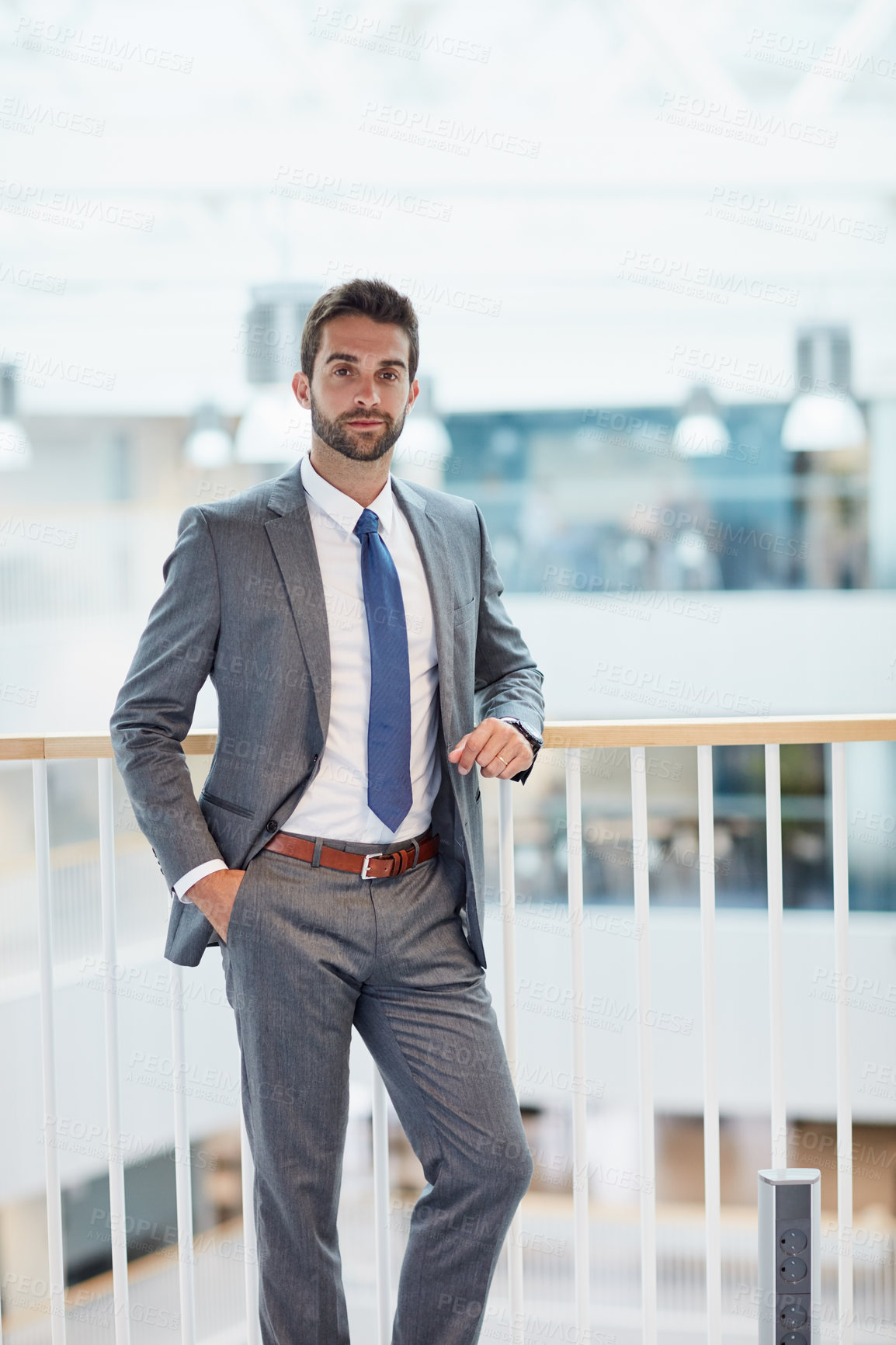 Buy stock photo Portrait of a confident young businessman standing in an office