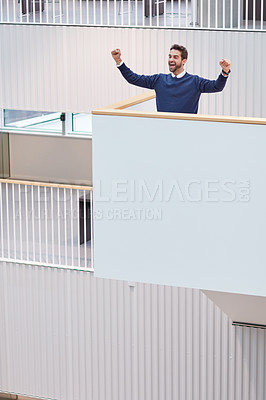 Buy stock photo Shot of a young businessman cheering in an office