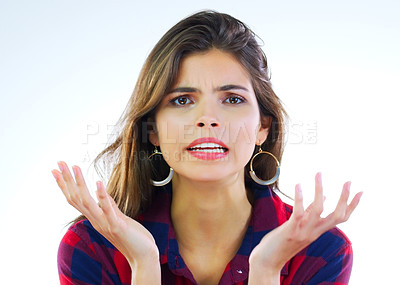 Buy stock photo Portrait of a young woman looking displeased against a white background