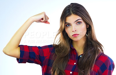 Buy stock photo Cropped shot of a young woman flexing her muscles against a white background