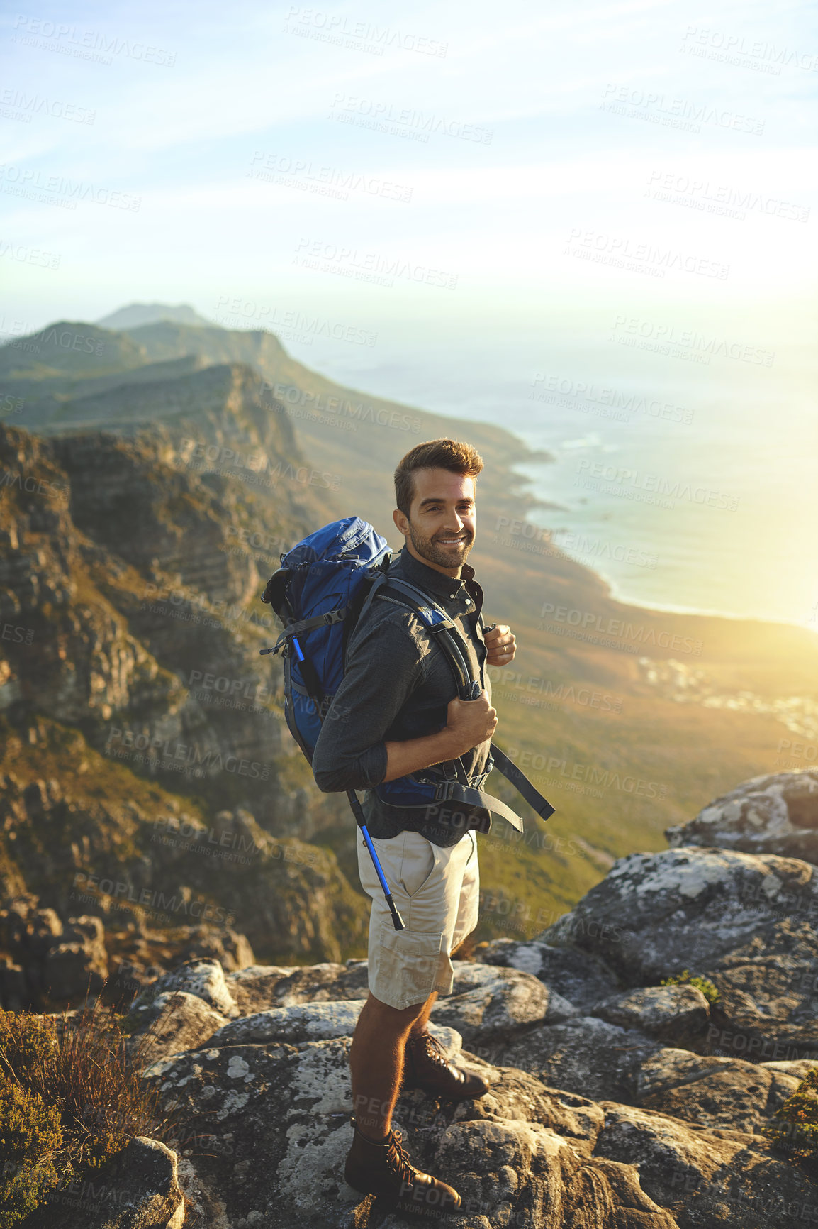 Buy stock photo Portrait, mountains and hiking with man, view and journey with nature, environment and getaway trip. Ocean, person and hiker with backpack, adventure and fitness with happiness, holiday and wellness