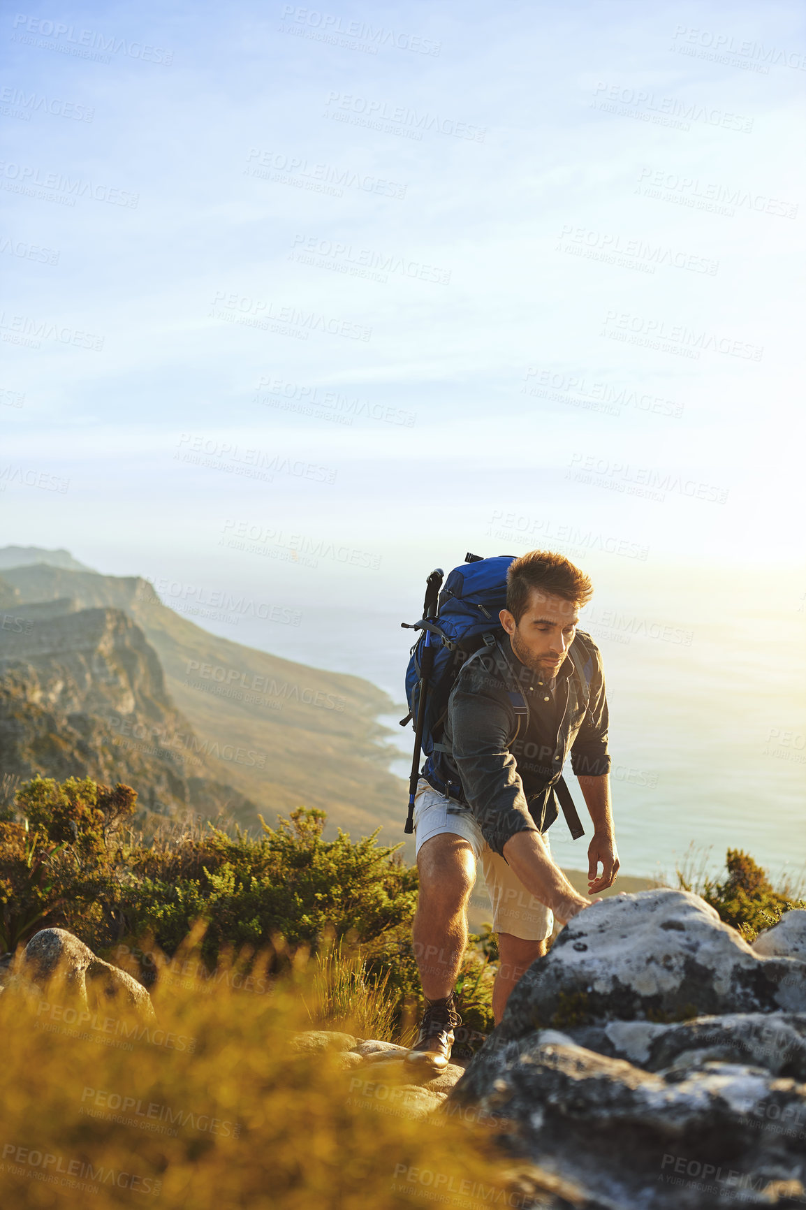 Buy stock photo Man, hiking and mountain with rocks outdoor of fitness adventure, sports challenge and travel health. Male person, backpack and vacation with trekking, balance and climbing exercise for explore trip
