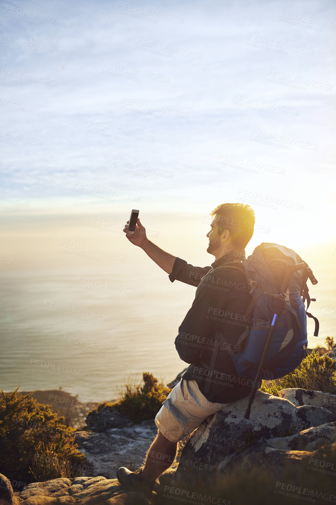 Buy stock photo Selfie, beach and man with backpack, hiking and view with adventure, vacation and ocean. Outdoor, hiker and healthy person with cellphone, coastline and getaway trip with internet, seaside or journey