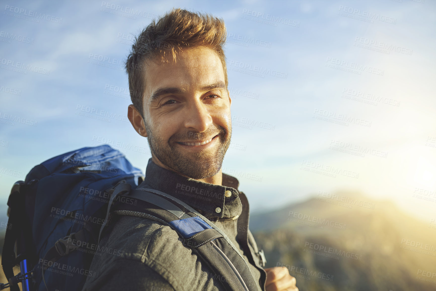 Buy stock photo Portrait, mountains and hiking with man, journey and happiness with nature, sunshine and getaway trip. Face, person and hiker with backpack, adventure and travel with wellness, holiday and fitness