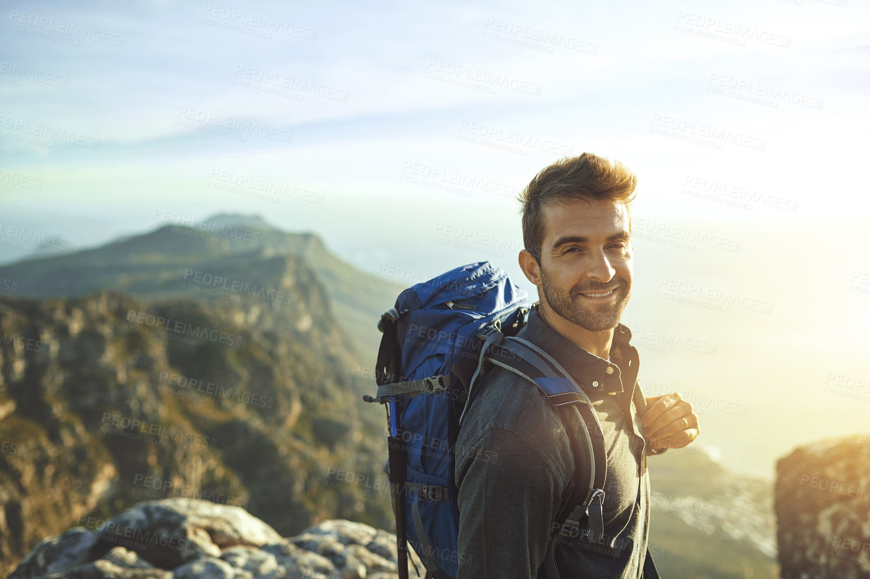 Buy stock photo Portrait, sunshine and hiking with man, fitness and journey with nature, smile and getaway trip. Wellness, person and hiker with backpack, adventure and vacation with happiness, holiday and mountains