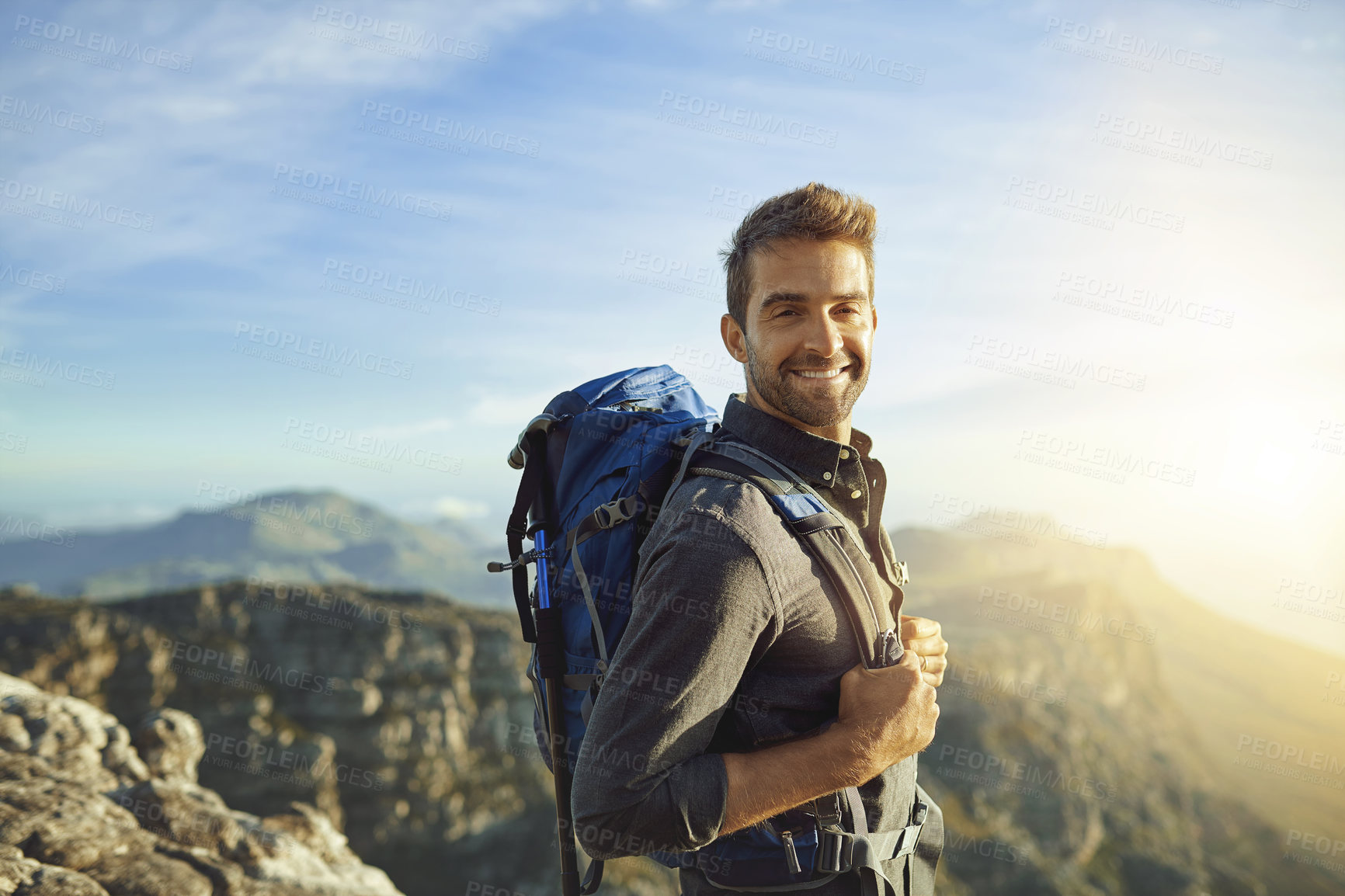 Buy stock photo Portrait, mountains and hiking with man, nature and journey with wellness, sunshine or getaway trip. Walking, person and hiker with backpack, adventure or environment with happiness, holiday or smile