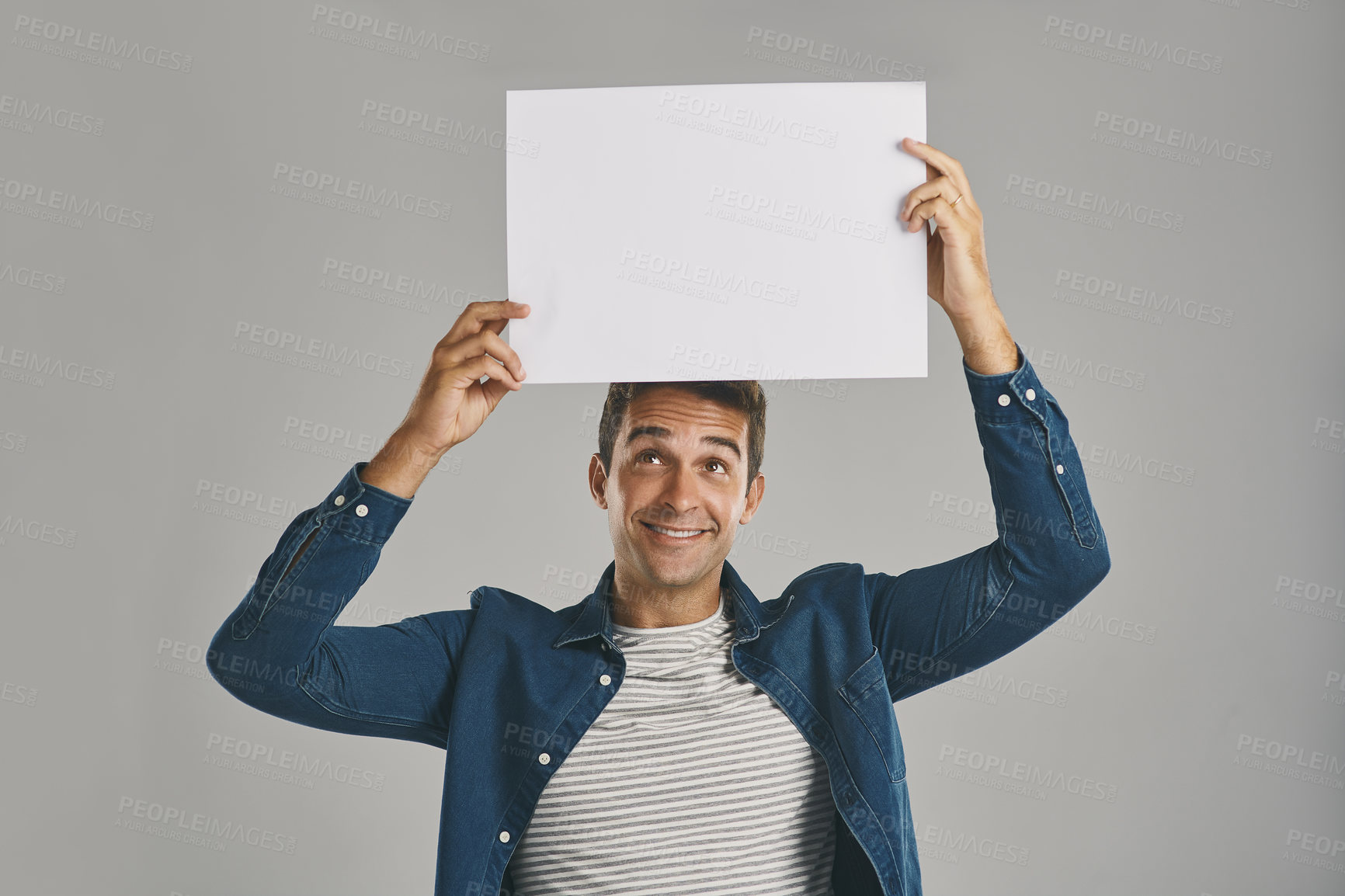 Buy stock photo Smile, blank and placard with man in studio for billboard announcement, presentation and branding logo. Male person, paper and advertising for news poster, signage and notification on gray background