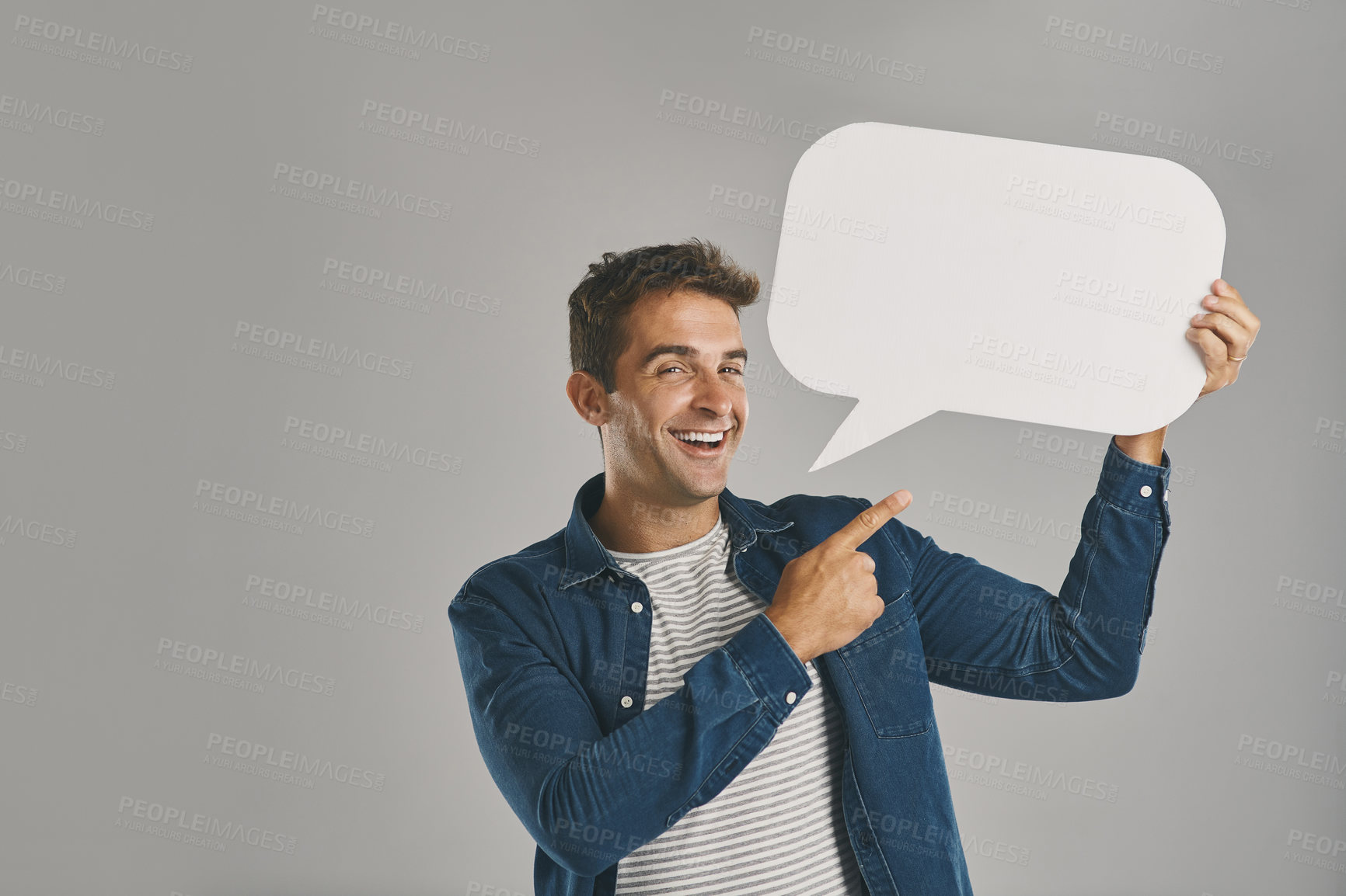 Buy stock photo Speech bubble, man and pointing with portrait, poster or guy on gray studio background. Person, mockup space or model with social media, communication or blank billboard with branding placard or chat