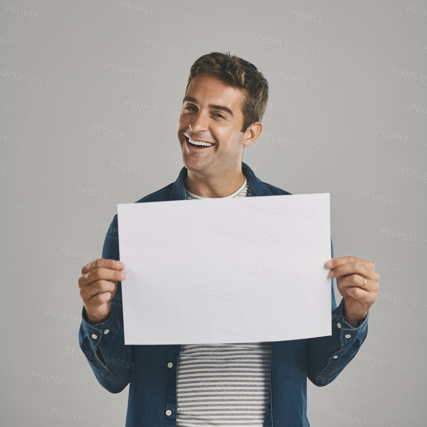 Buy stock photo Man, portrait and poster mockup in studio or announcement placard for advertising space, promotion or grey background. Male person, face and information sign for news deal, ambassador or customer