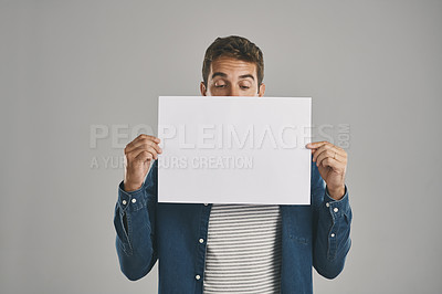 Buy stock photo Man, blank and placard with paper in studio of billboard announcement, presentation and branding logo. Male person, notice and advertising for news poster, signage and notification on gray background